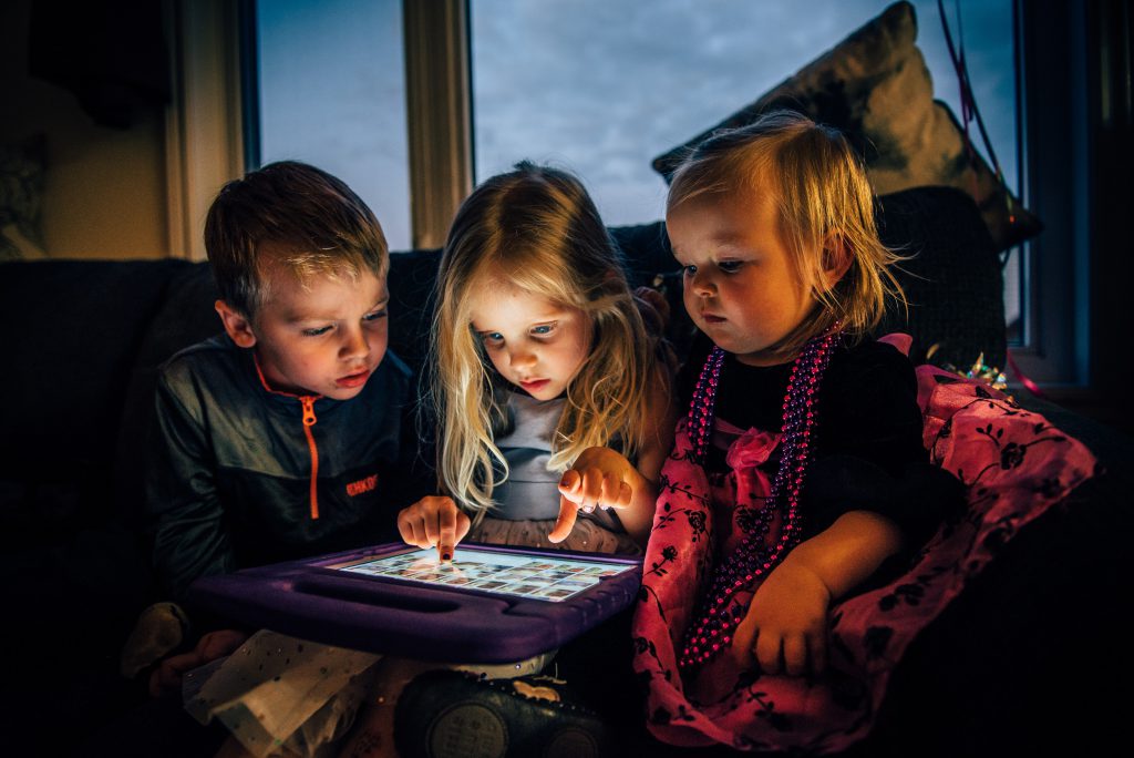 Three children using tablet